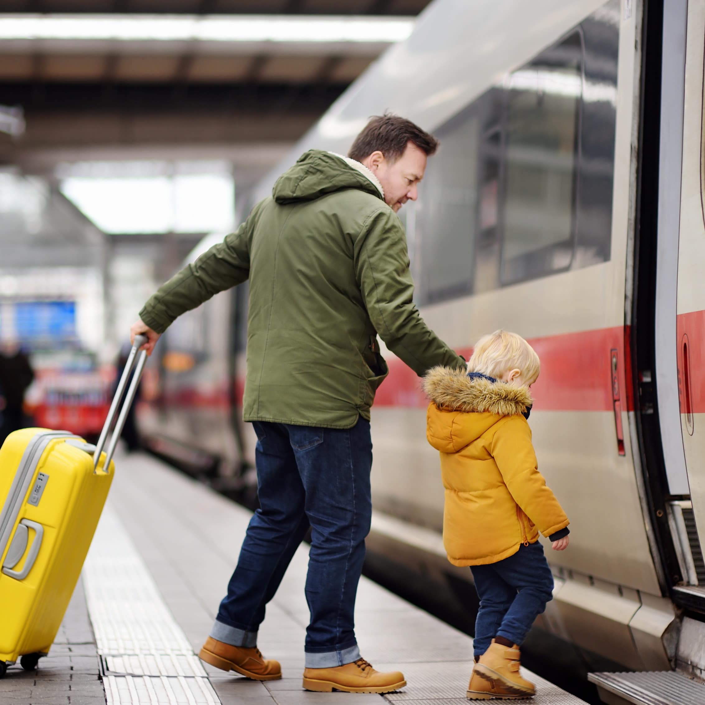 Father and son boarding train